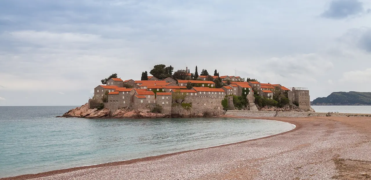 The fortified islet of Sveti Stefan with its red roofs and pink-sand beach linked to the shore by a causeway