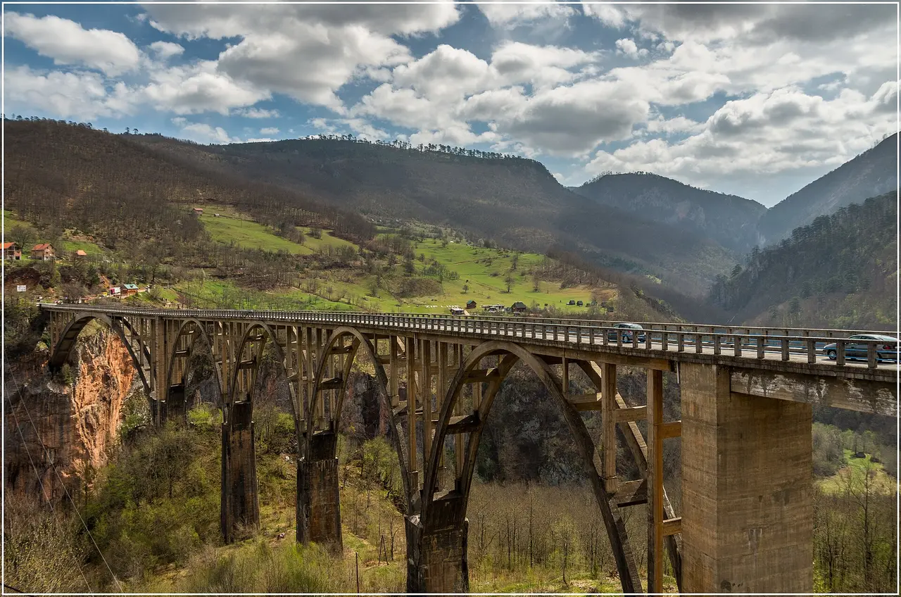 The arched Đurđevića Tara Bridge spanning the deep Tara River canyon under wooded slopes