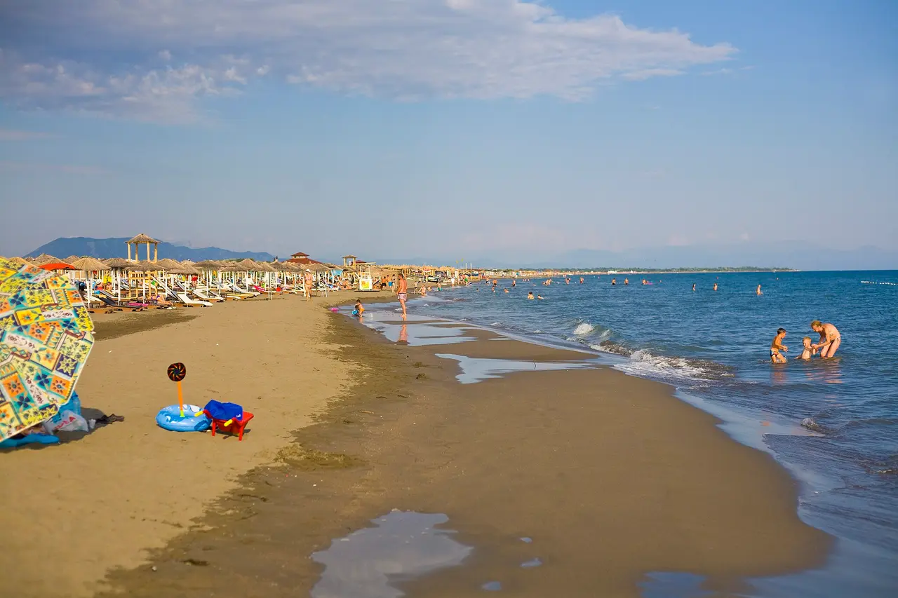 Families wading in the shallow water of the long sandy beach at Ulcinj, southern Montenegro