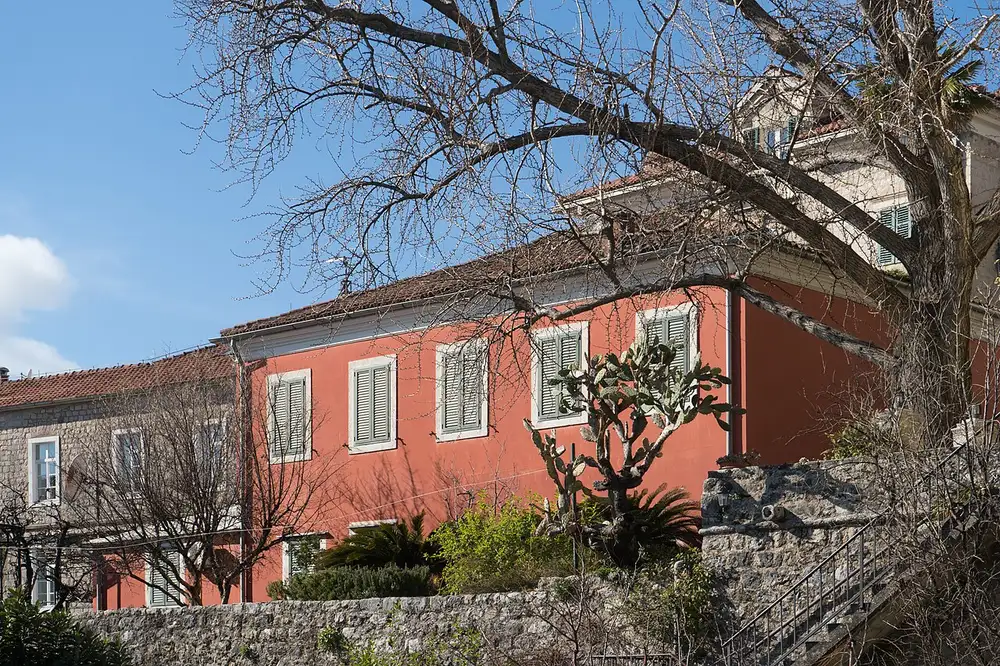 Stone houses and a cafe terrace on a square in Herceg Novi Old Town