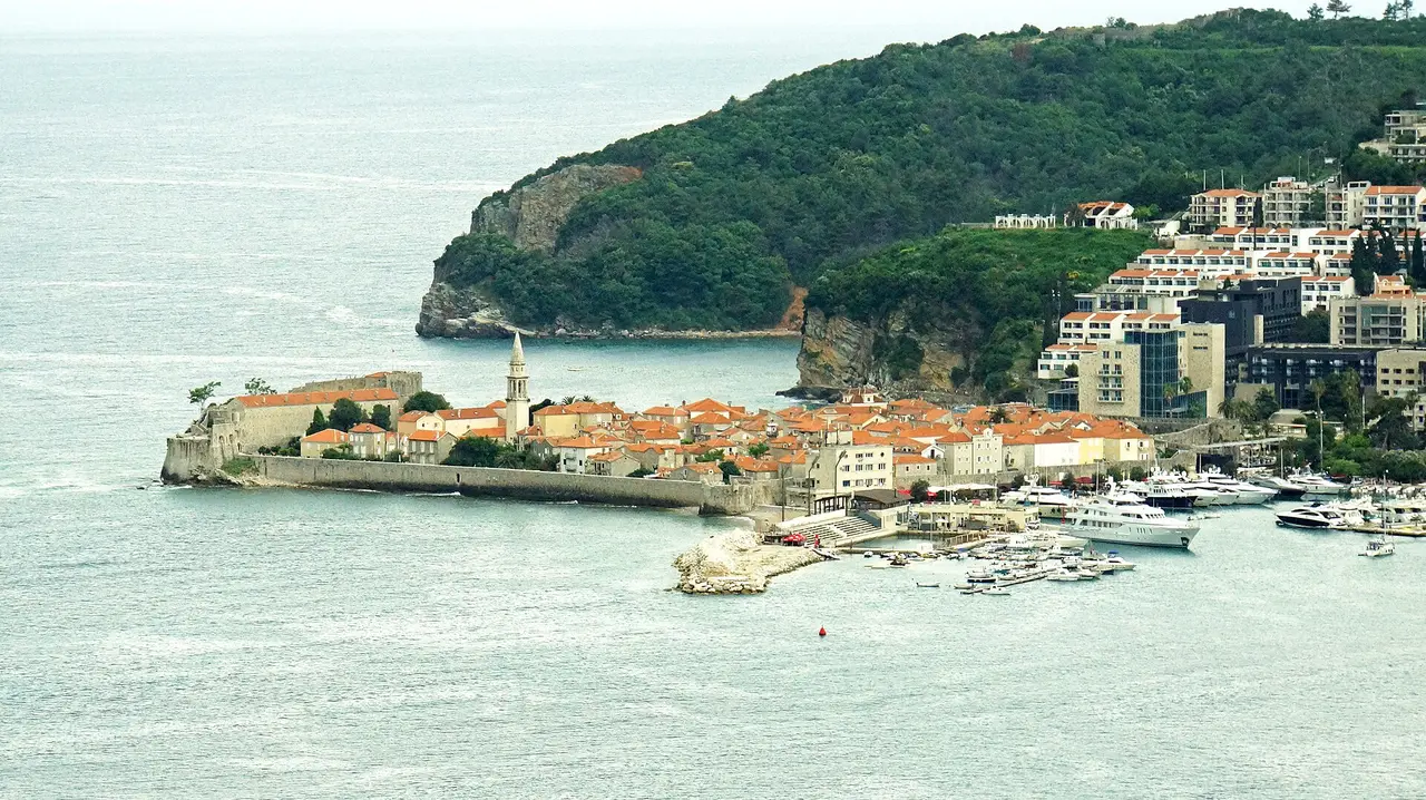 View over the Montenegrin coast with a resort town on the bay and mountains behind