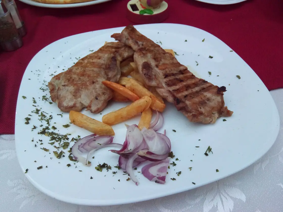 A plated pork fillet dish served at a Montenegrin restaurant