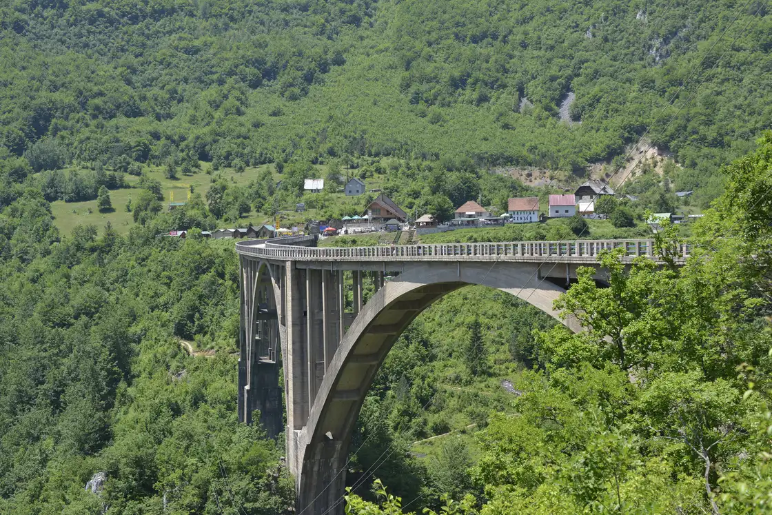 The tall concrete arches of the Djurdjevica Tara bridge spanning the deep green Tara canyon