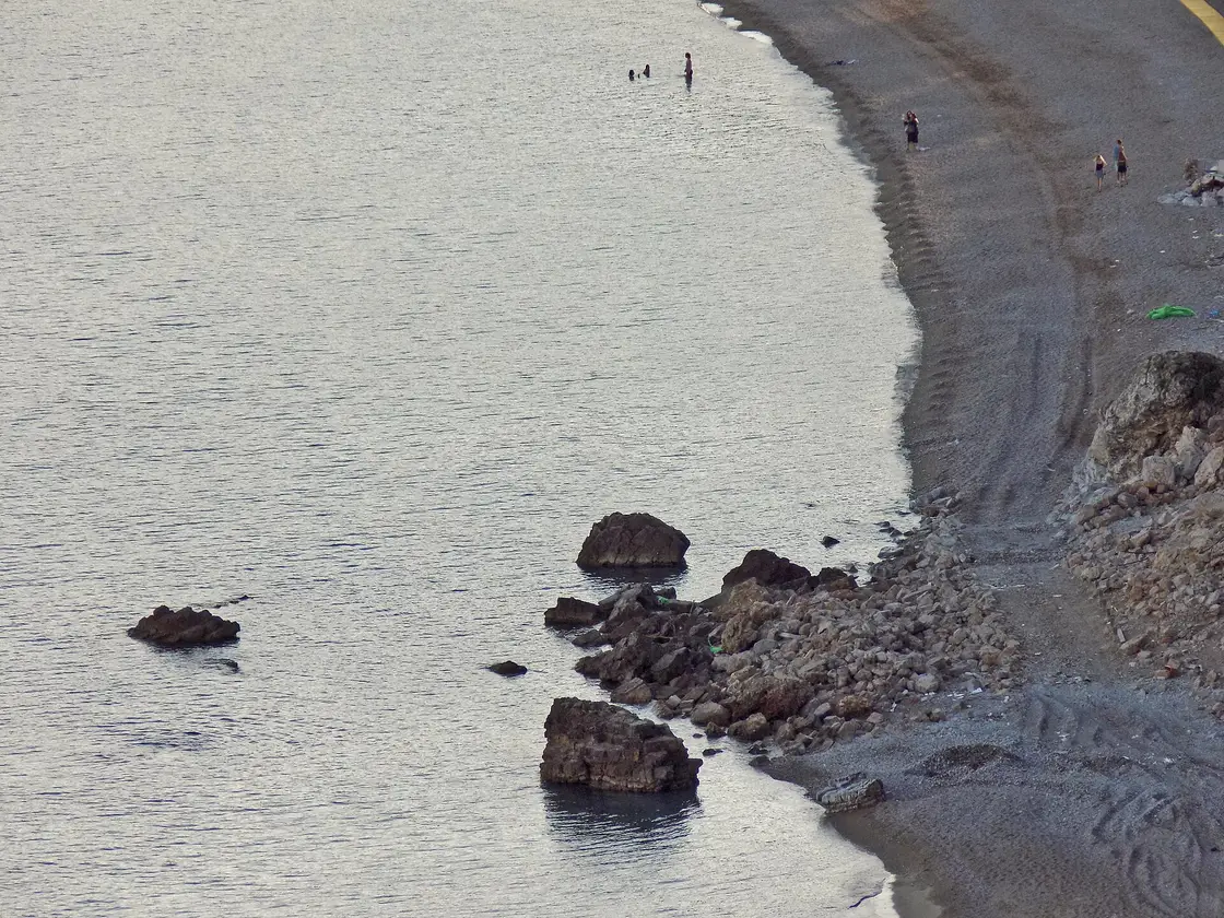 The wide, gently shelving sand and shingle of Jaz Beach near Budva, Montenegro