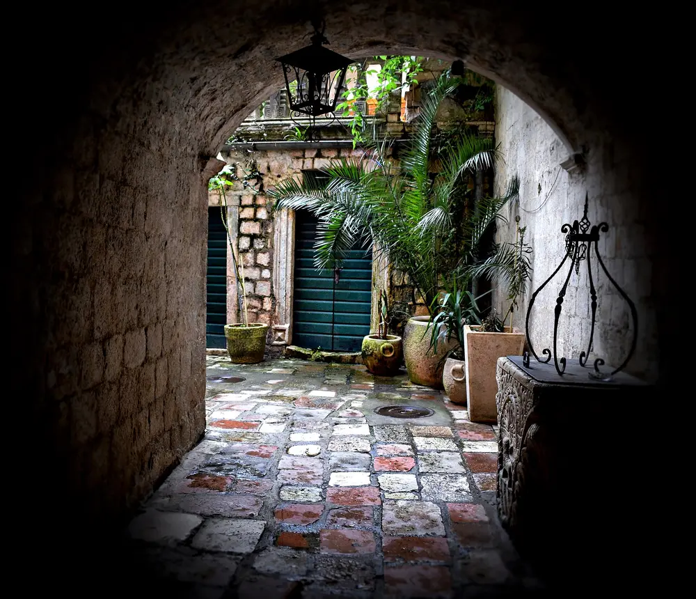 A narrow, car-free stone lane in the old town of Kotor, Montenegro