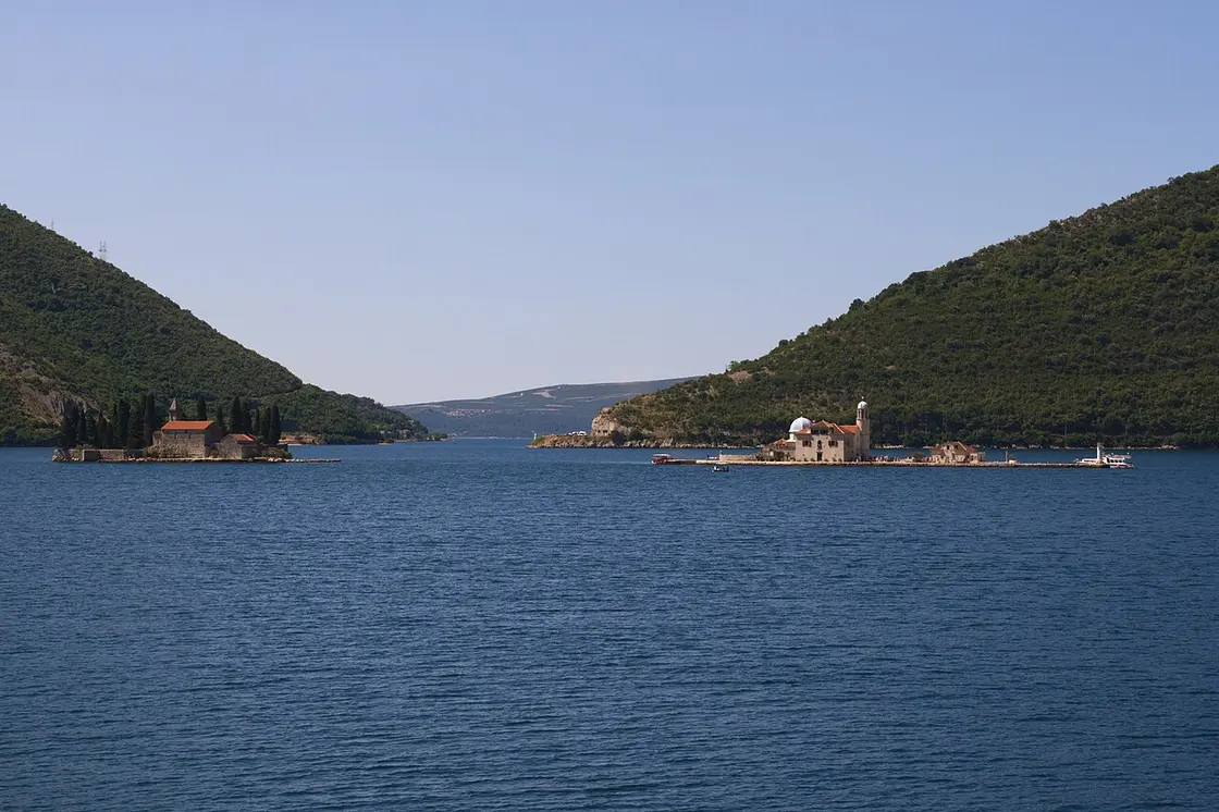 The twin islets of Our Lady of the Rocks and St. George off Perast, seen across the Bay of Kotor, Montenegro