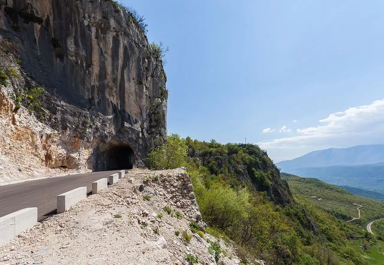Narrow mountain switchback road cut into the cliff on the way up to Ostrog Monastery