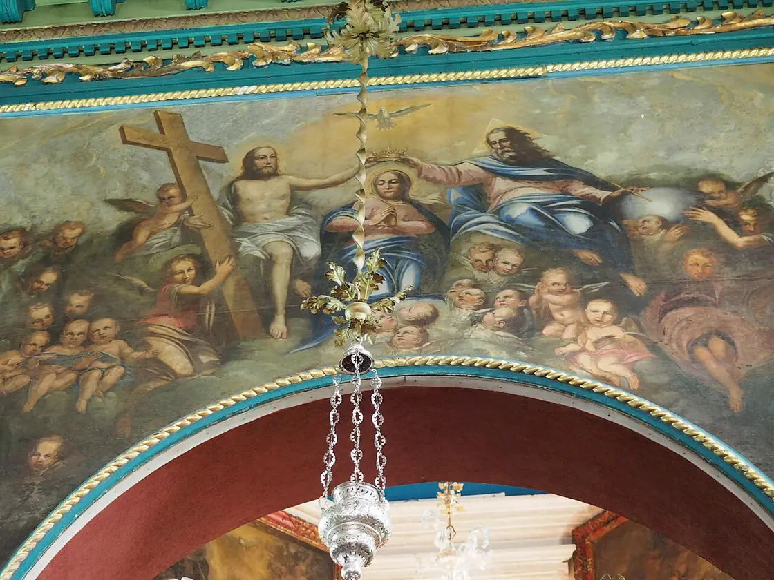 A Baroque ceiling painting of the Coronation of the Virgin with cherubs inside the church of Our Lady of the Rocks