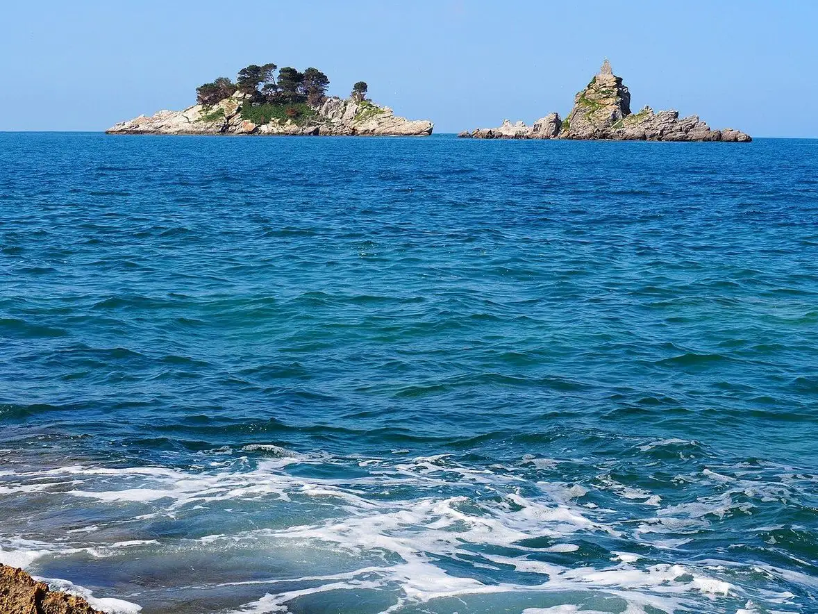 The two rocky islets of Katic and Sveta Nedjelja in the sea off Petrovac, one wooded and one bare with a small chapel