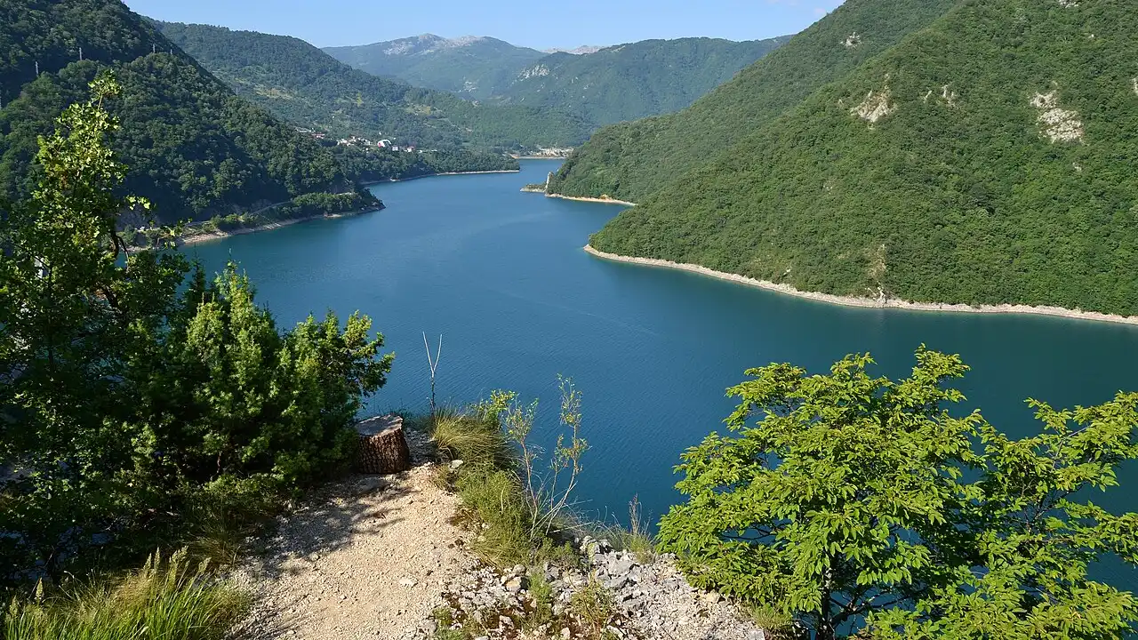 Turquoise Piva Lake filling a narrow canyon in northwestern Montenegro, forested cliffs rising from the water