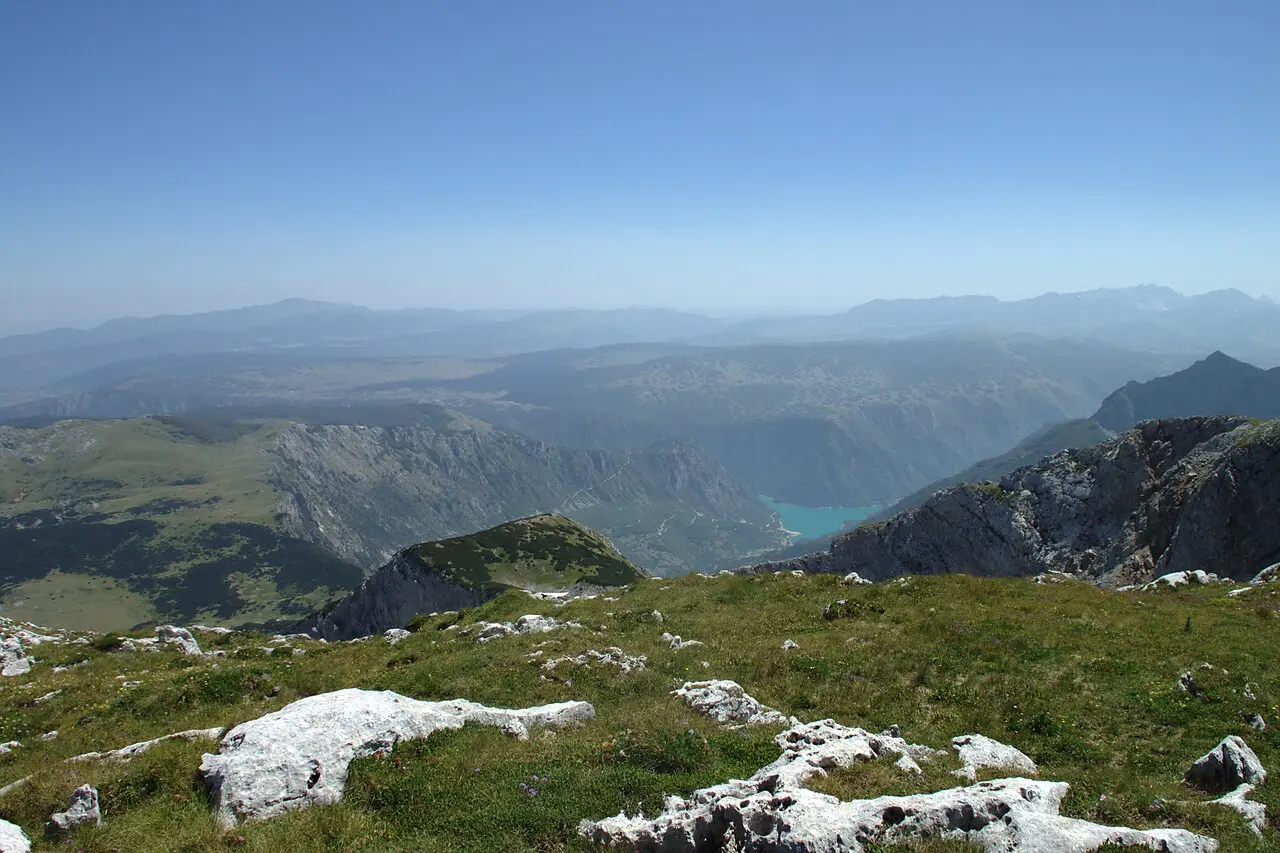 Piva Lake seen from high on Maglić mountain, peaks and forest in the foreground