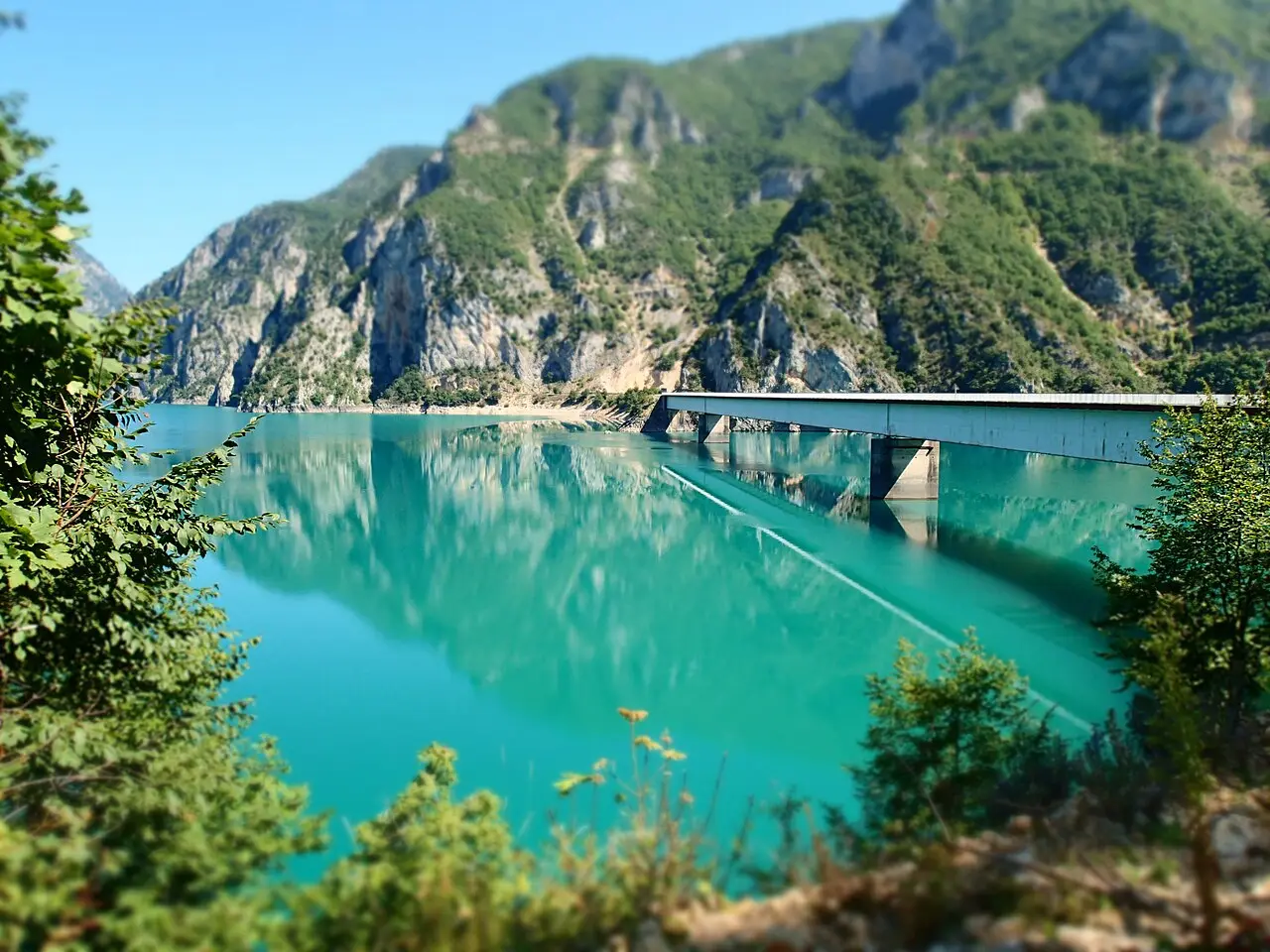 A road bridge over Piva Lake near Plužine with mountains behind