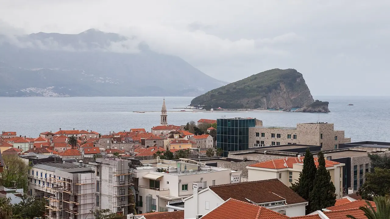 Budva old town with the church bell tower and the island of Sveti Nikola offshore, the destination from Podgorica Airport