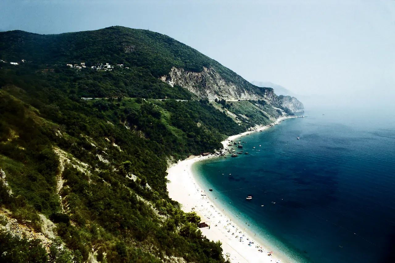 Adriatic coastal highway and steep cliffs near Jaz beach on the approach to Budva