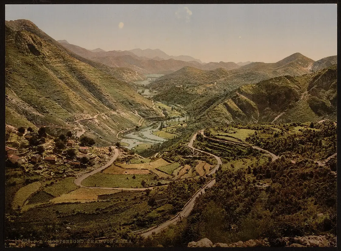 A hand-tinted photochrom postcard from around 1900 showing the winding road down the Rijeka valley toward Lake Skadar