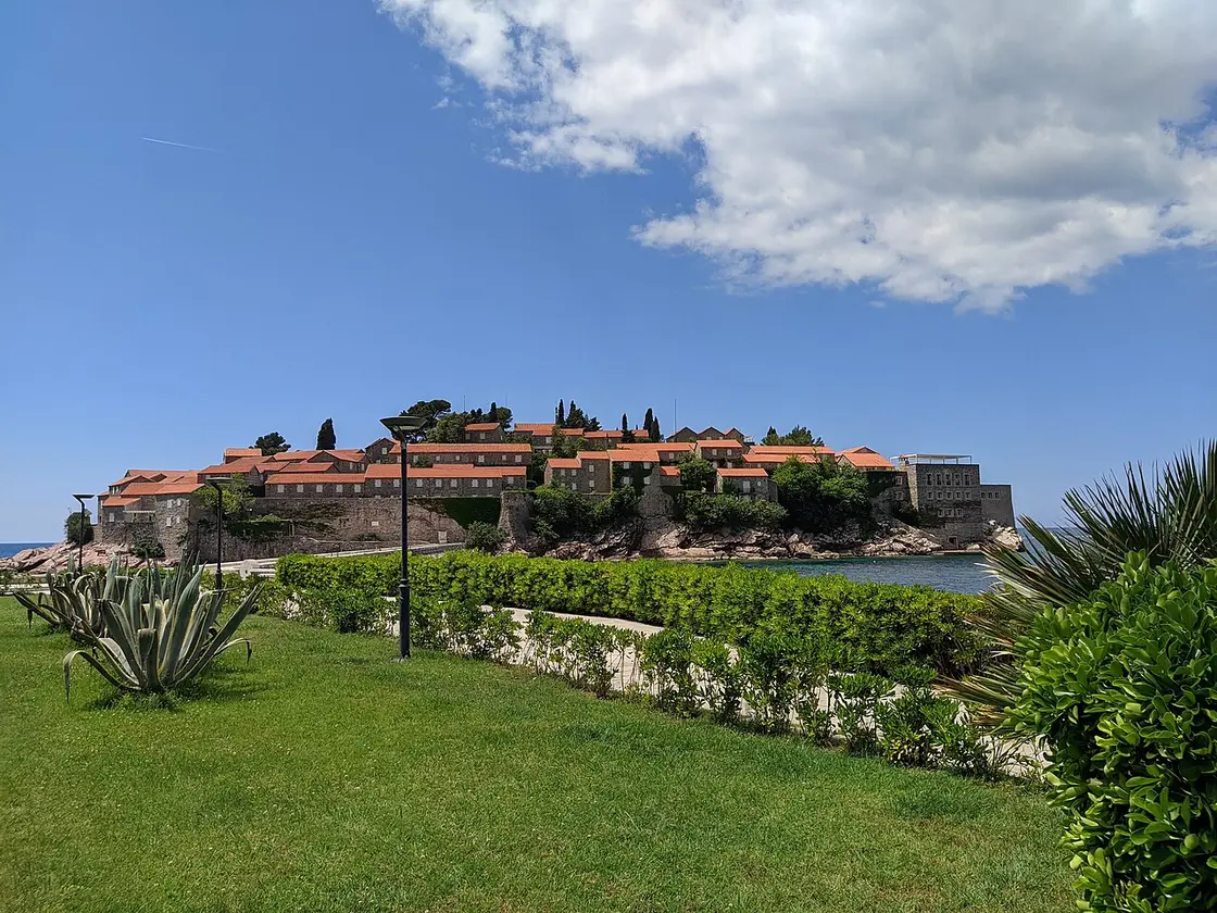 The island of Sveti Stefan seen from the paths of Milocer Park, with agave and gardens in the foreground