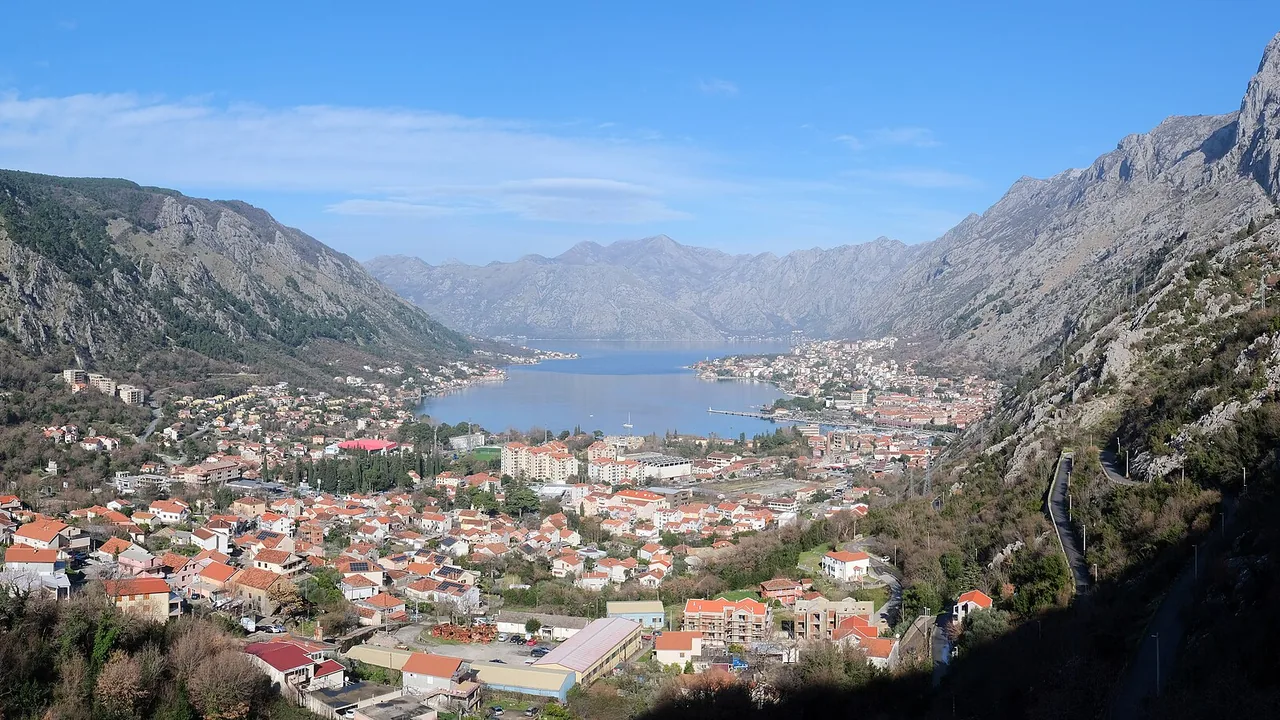 Wide view over the Bay of Kotor with calm water and mountains rising on both shores