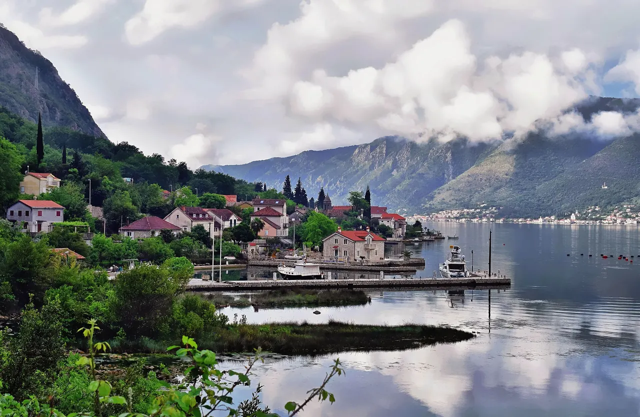 Looking along Dobrota on the Bay of Kotor with mountains across the water