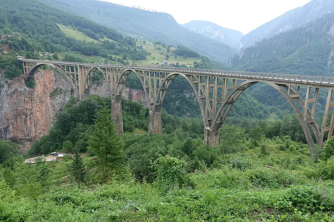 Side view of the five concrete arches of the Đurđevića Tara bridge above the canyon
