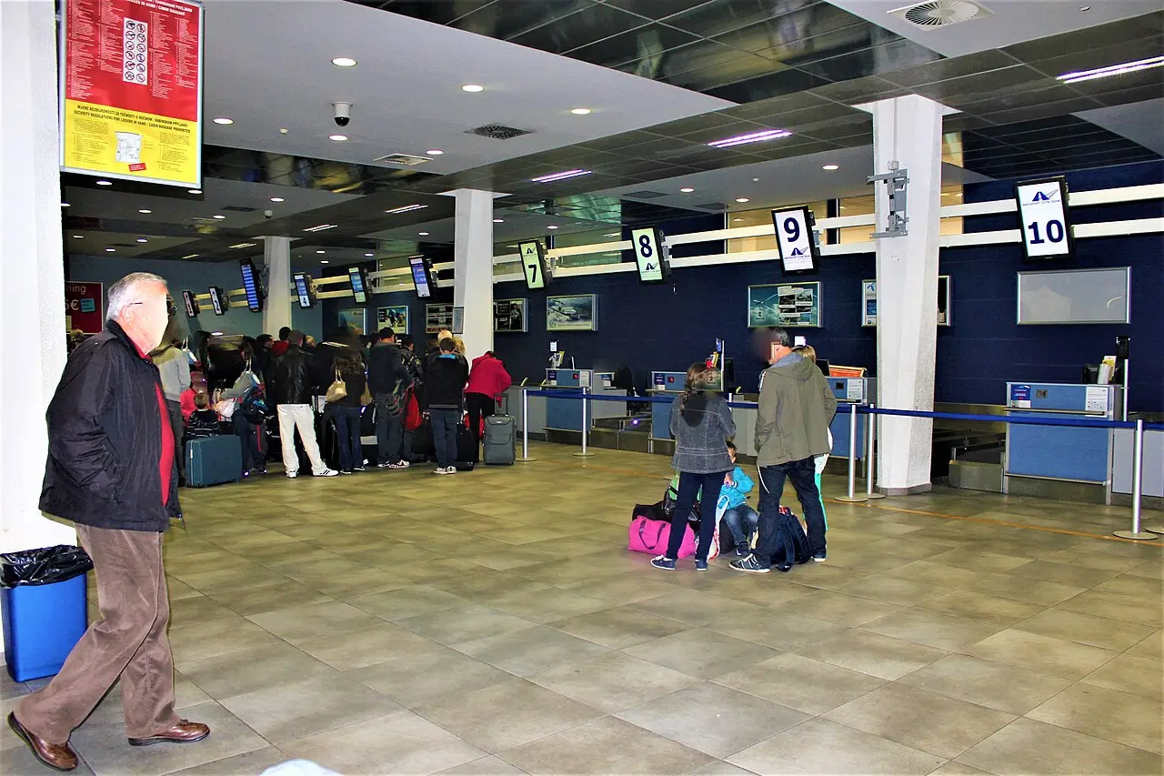 Passengers queueing at the check-in counters inside Tivat Airport terminal