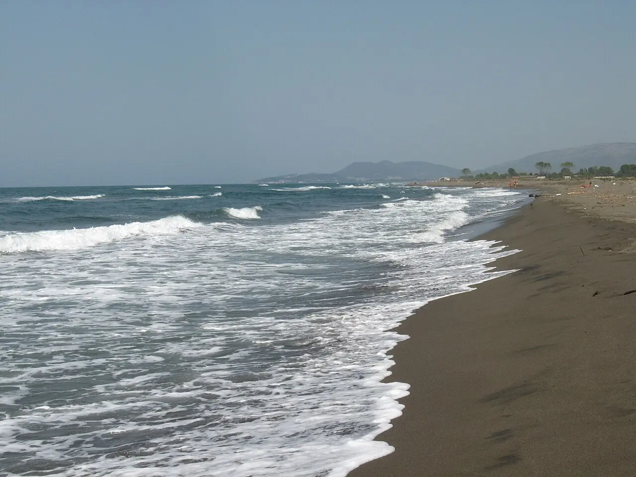 The wide, wild sandy beach of Ada Bojana with breaking waves and dunes