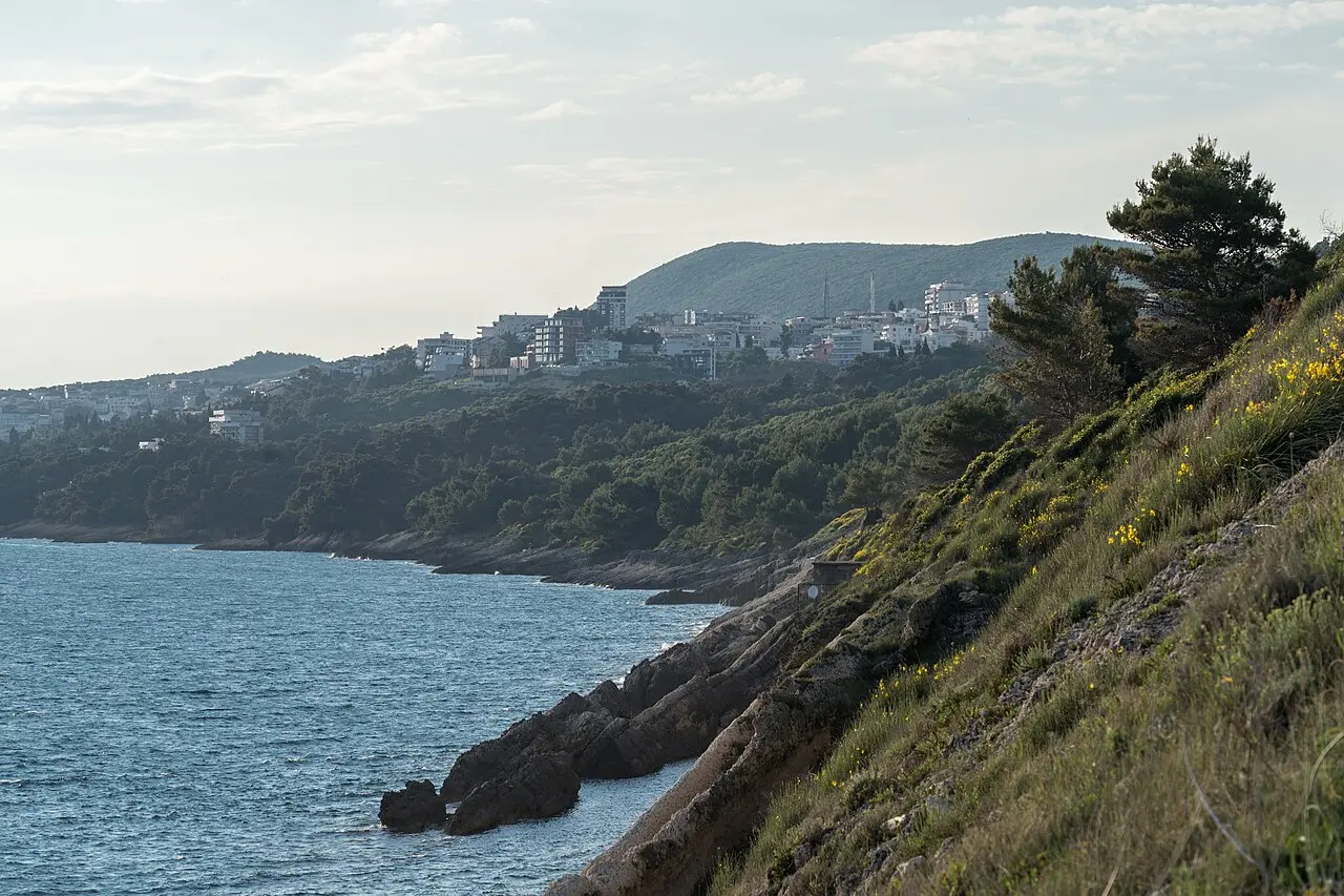 The town of Ulcinj on its wooded headland above the rocky Adriatic coast