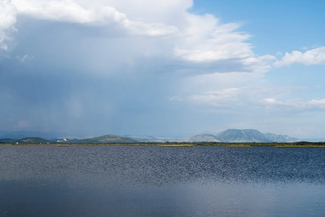 Open water and distant mountains at the Ulcinj Salina wetland under a big sky