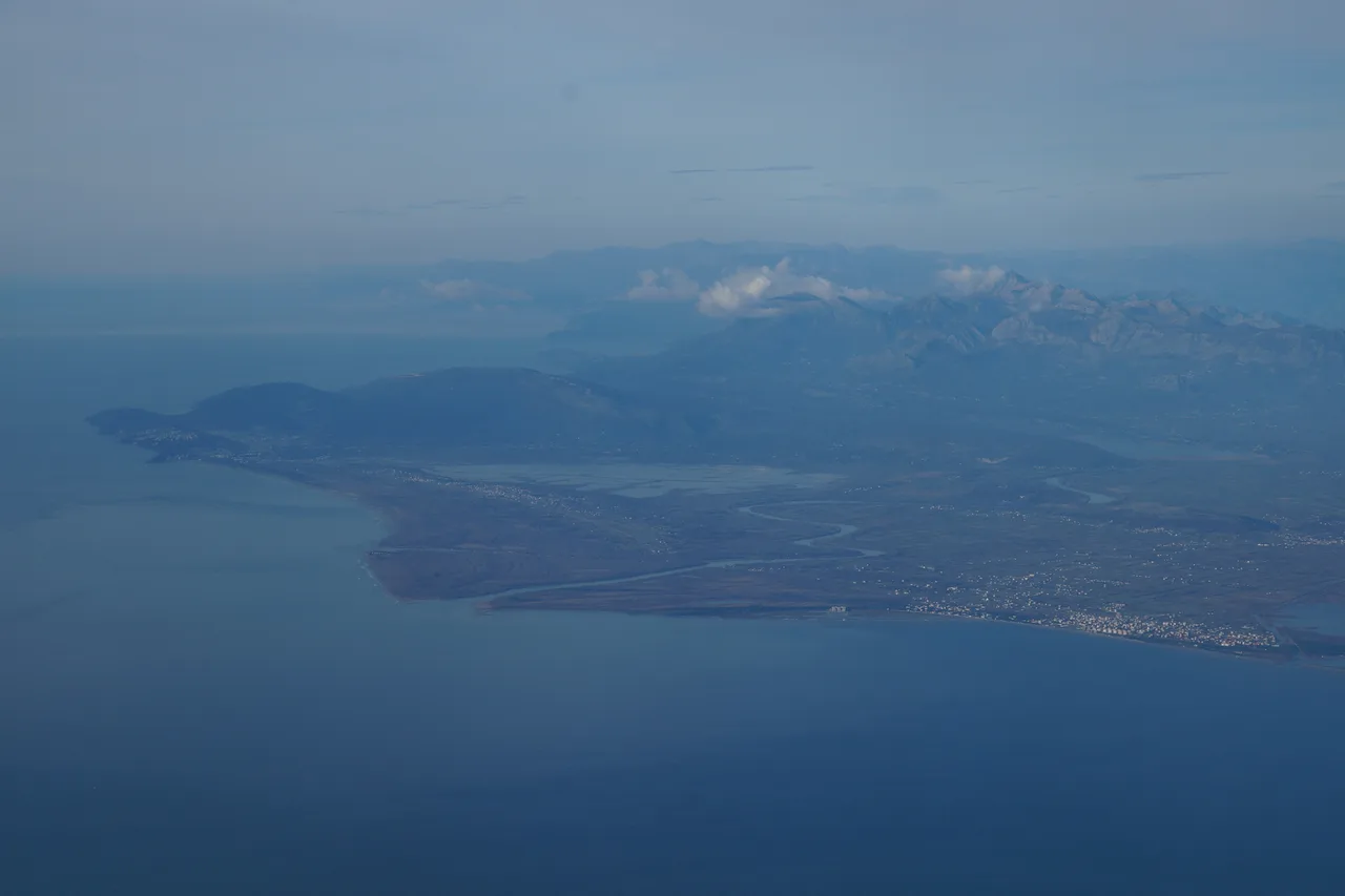 Aerial view of the Bojana river delta with sandbars, green wetlands and the sea beyond