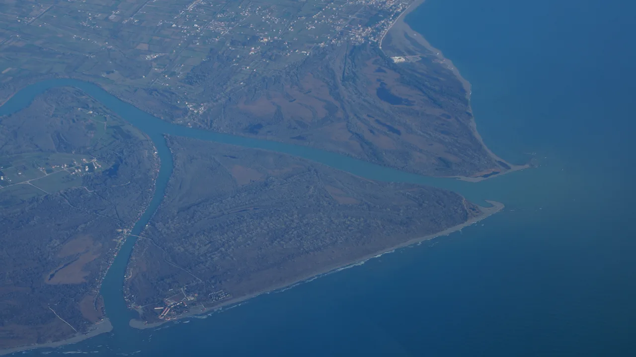 Aerial view of Ada Bojana island where the Bojana river meets the Adriatic, with sandbars and green wetlands at the Albanian border
