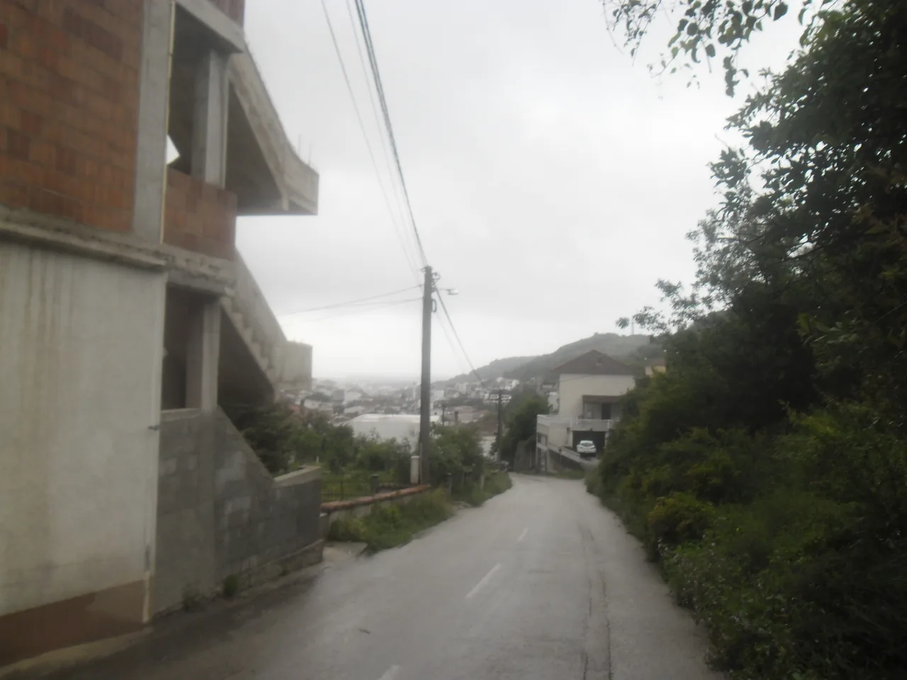 A narrow stone lane in Ulcinj Old Town with whitewashed walls and wooden doors
