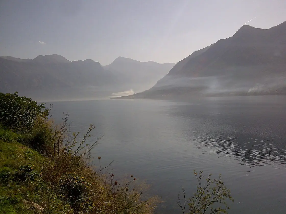 A misty, still bay near Baošići on the eastern end of the Herceg Novi riviera, mountains behind