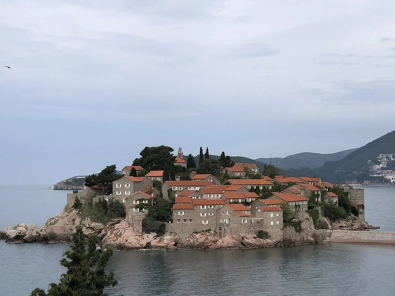 The fortified islet of Sveti Stefan joined to the mainland by a narrow causeway and beach