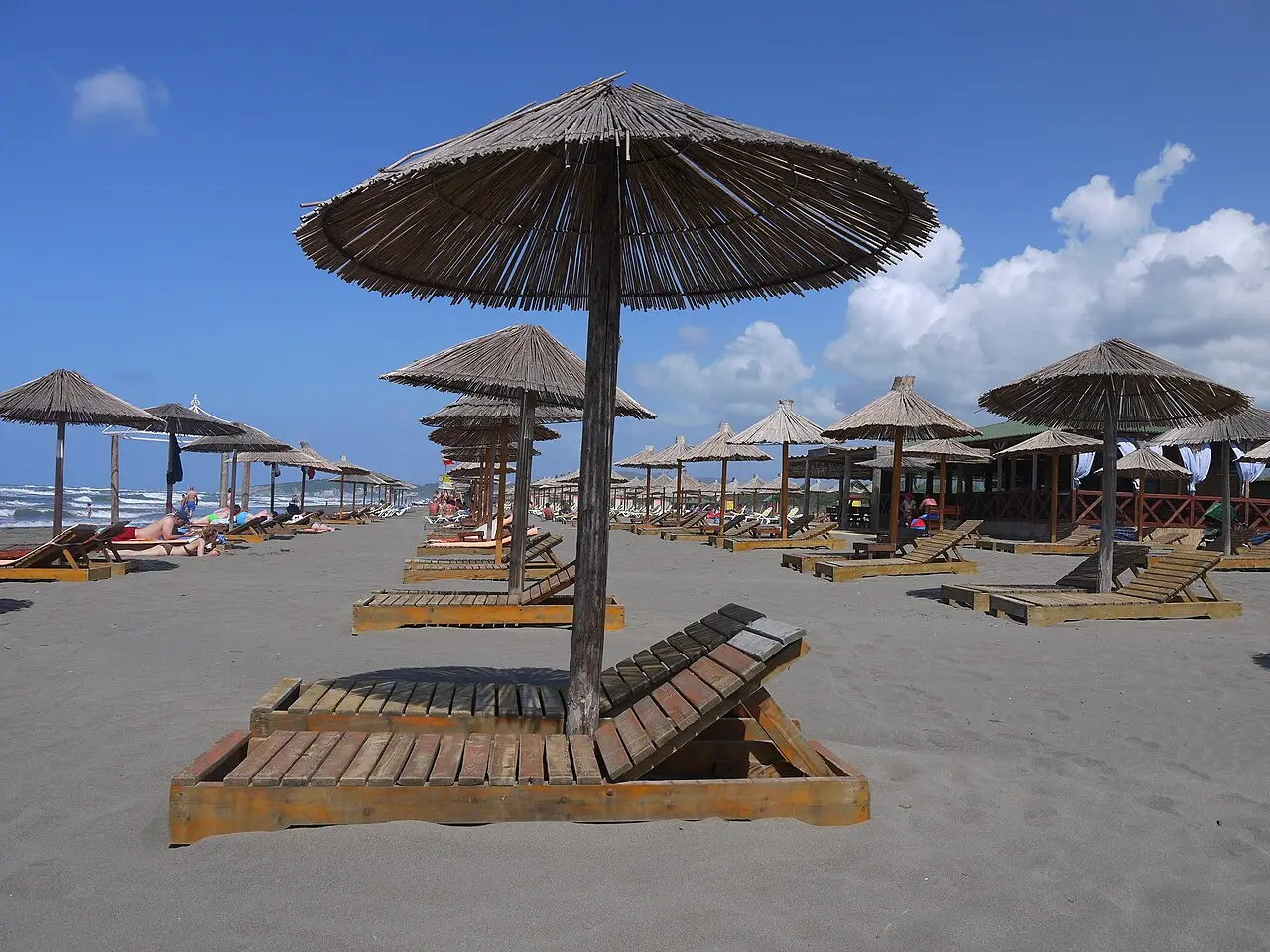 Sun loungers and umbrellas on the sandy Imperial Beach section of Velika Plaža near Ulcinj