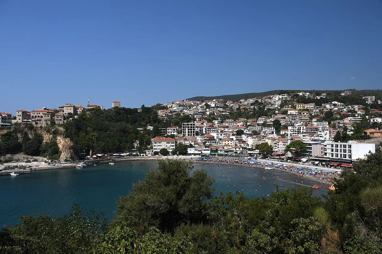 The bay of Ulcinj seen from above, with the town spread along the shoreline and the Adriatic opening out to the west