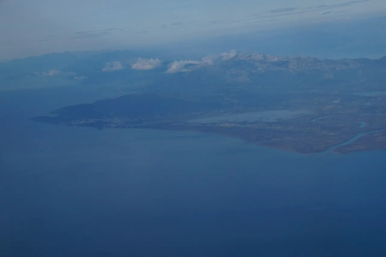 Aerial view of the long sandy Velika Plaža coastline near Ulcinj with shallow turquoise water